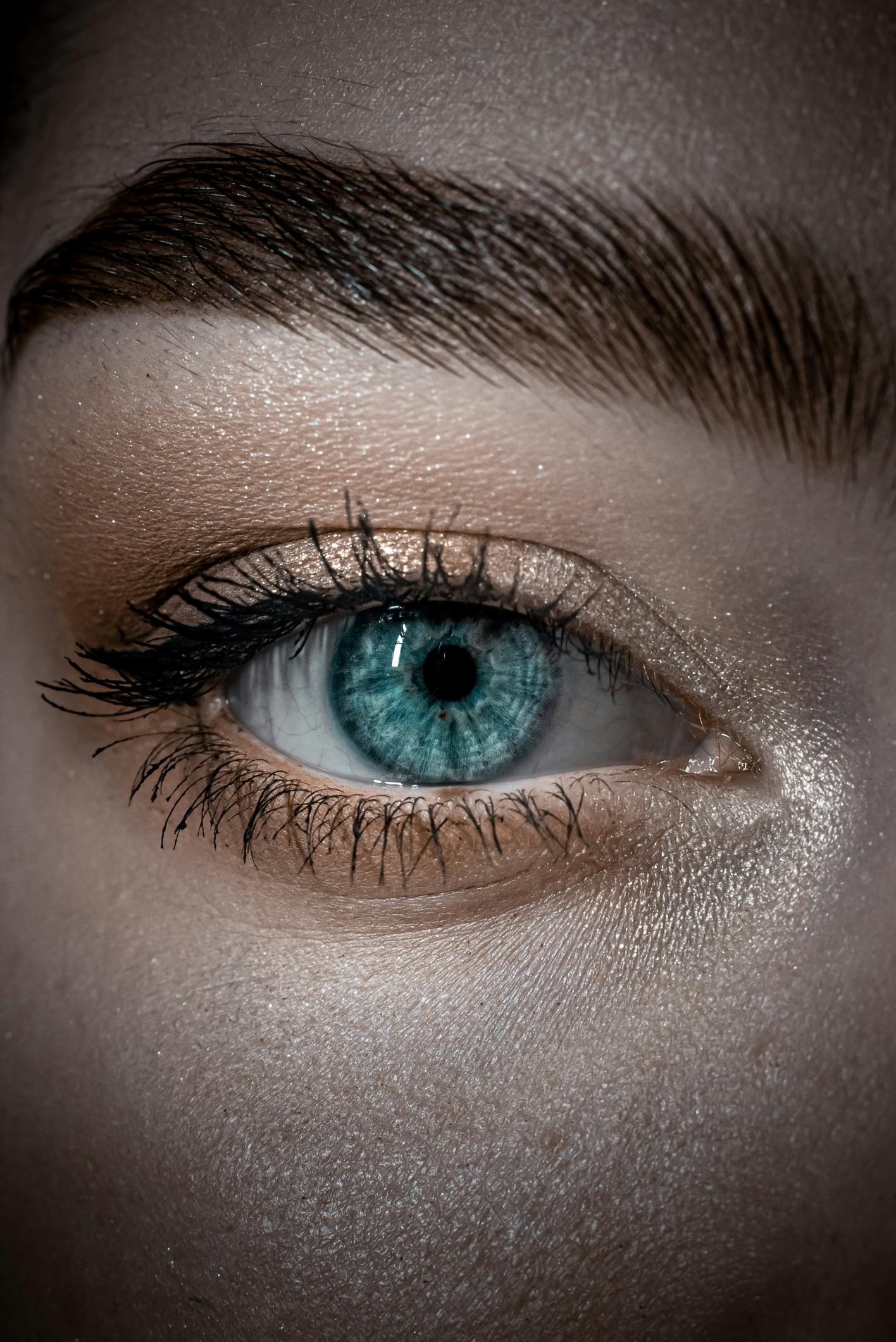 close up of a person looking at you with one blue eye